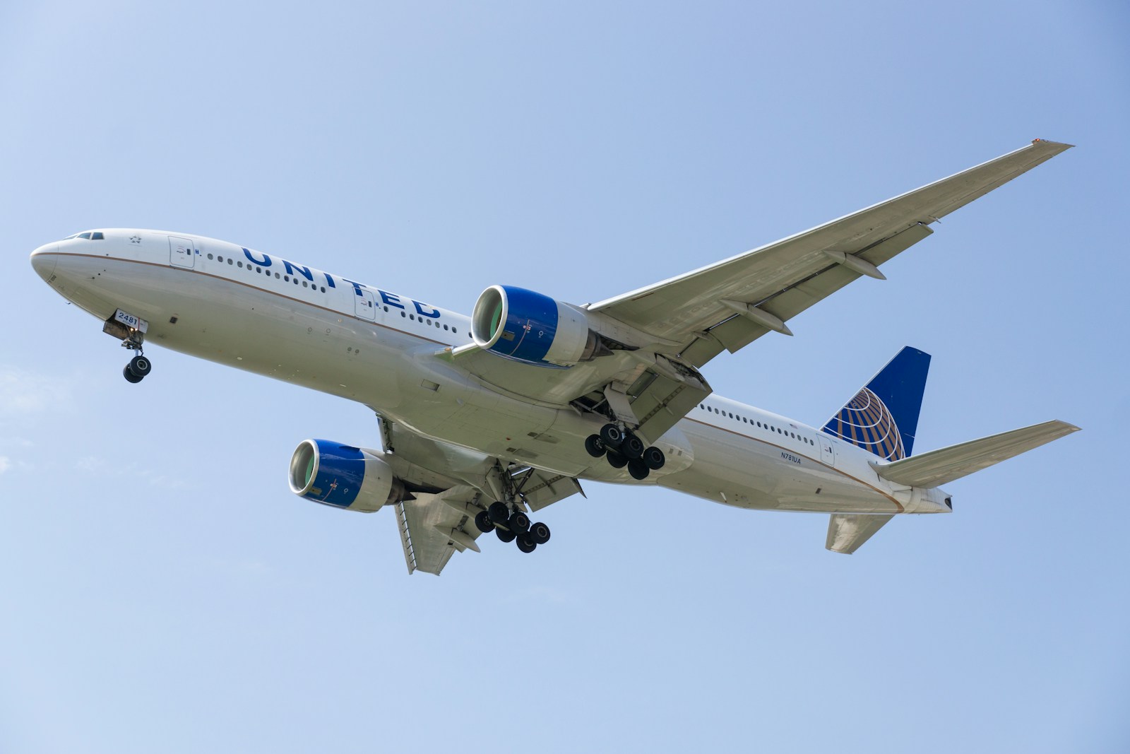 a large jetliner flying through a blue sky